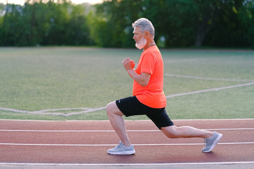 Side view of bearded male training and doing lunges