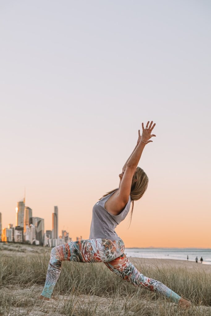 woman do lunges in white shirt raising her hands